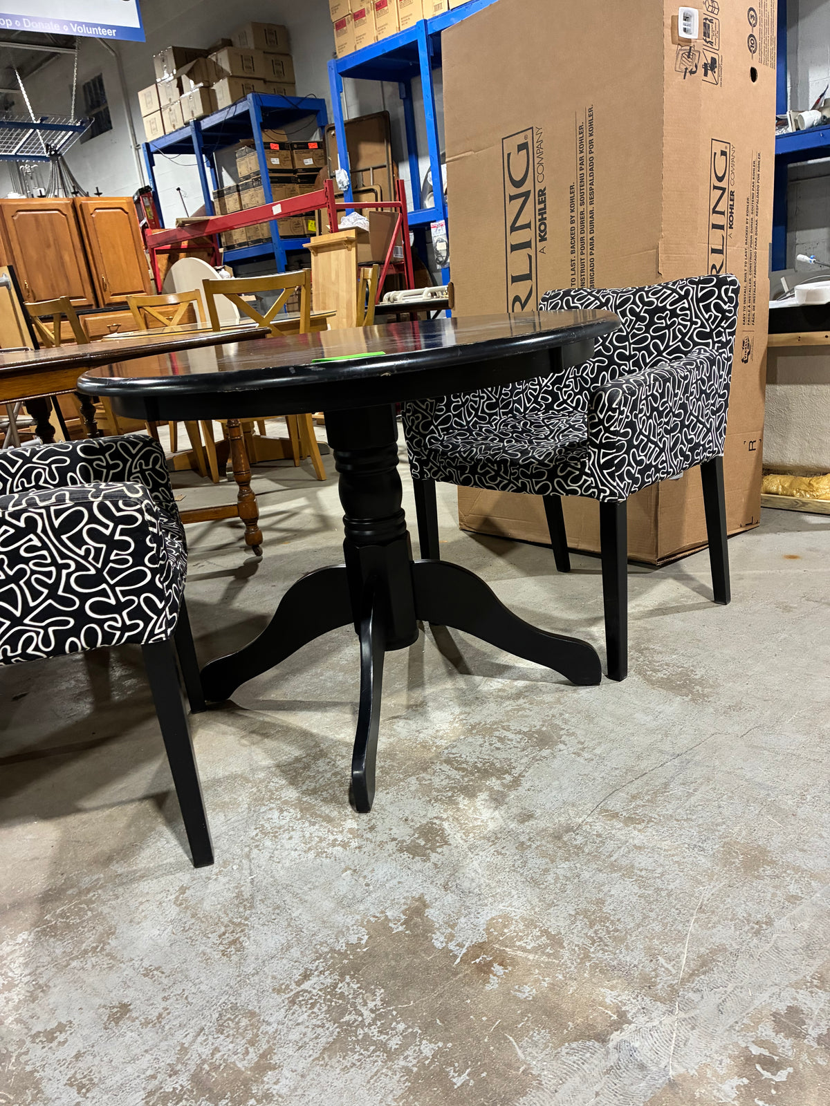 Black Round Pedestal Dining Table with Two Patterned Armchairs