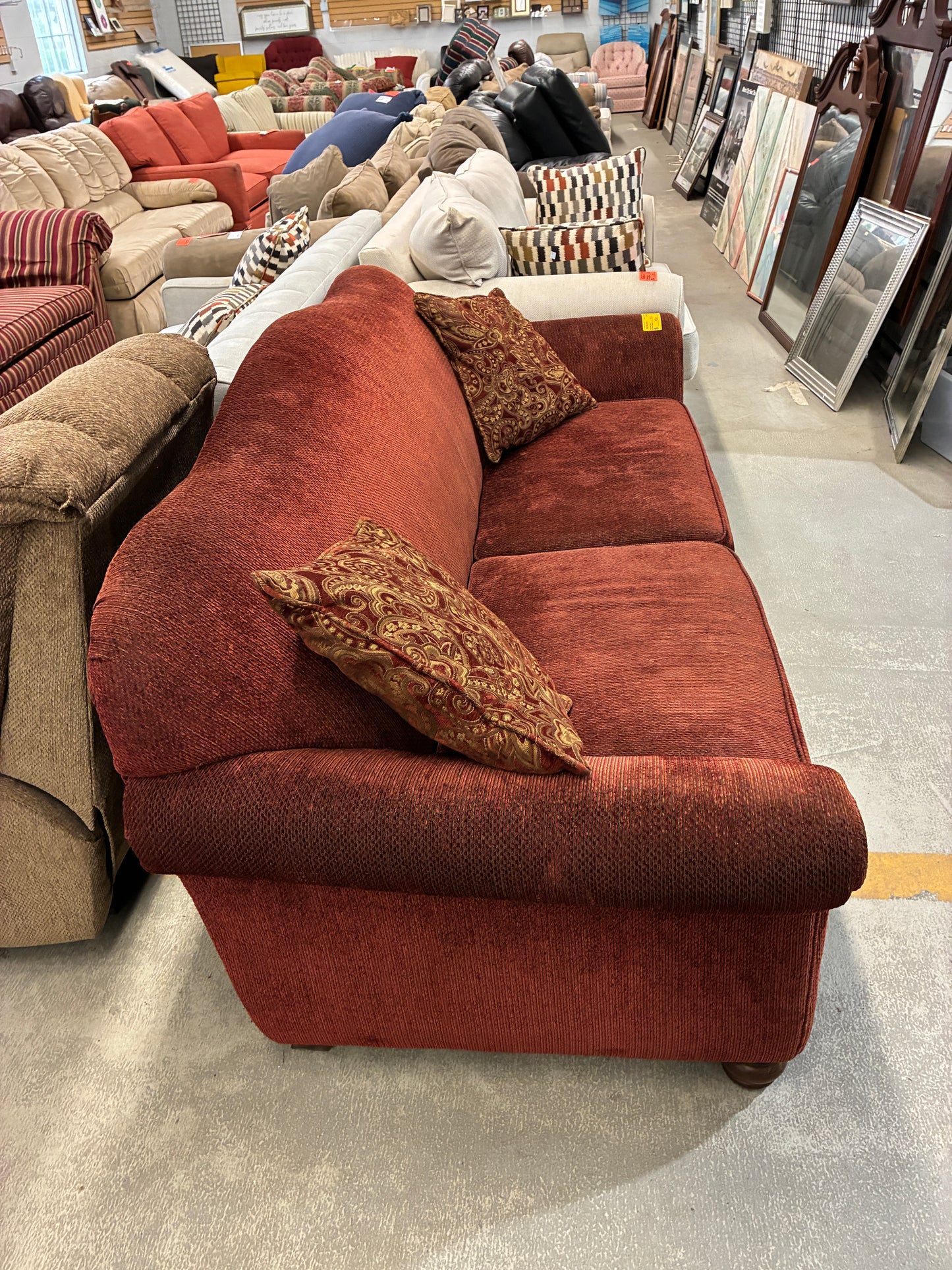 Red Upholstered Sofa with Accent Pillows