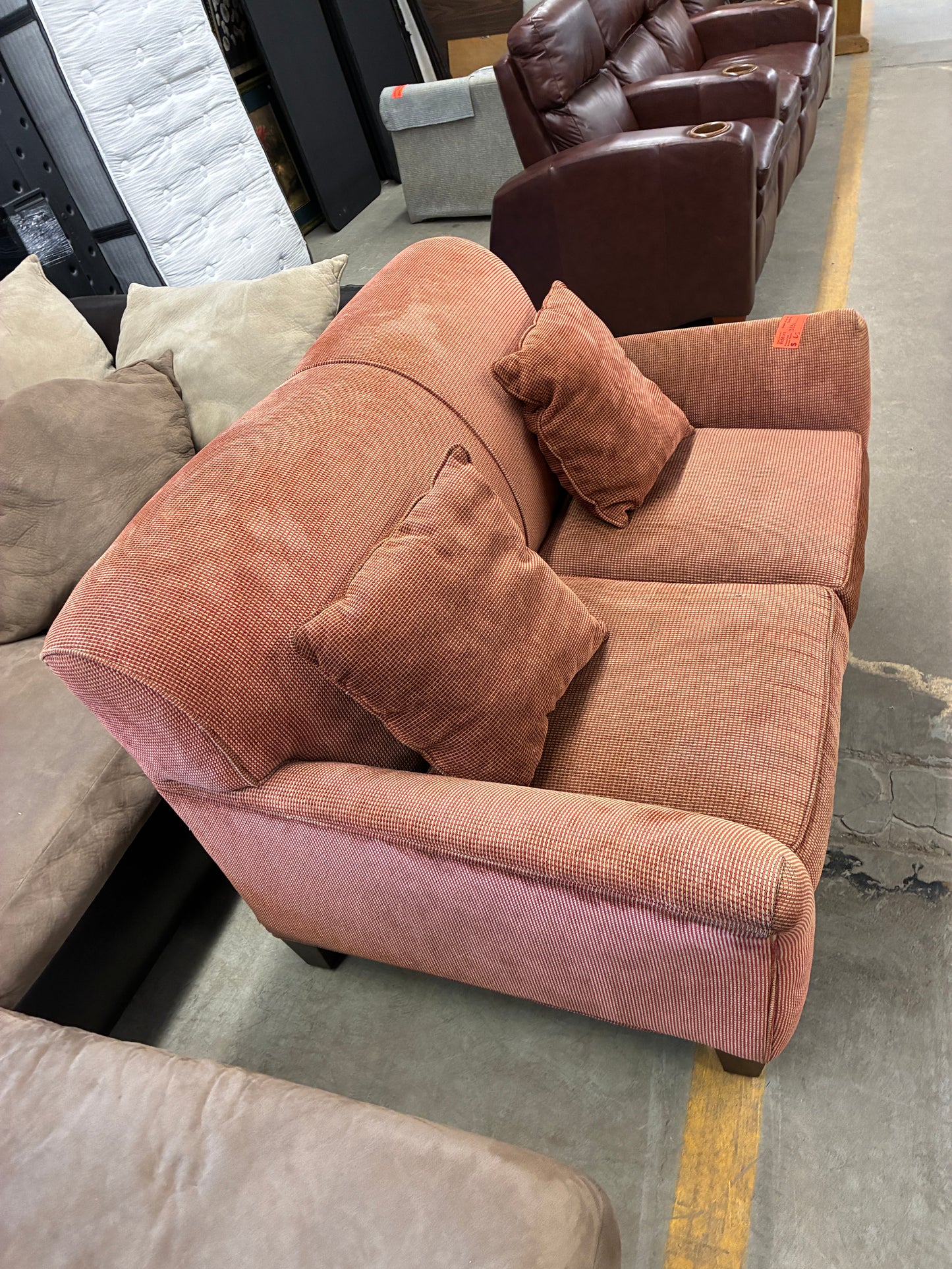 Light Red Textured Loveseat with Throw Pillows