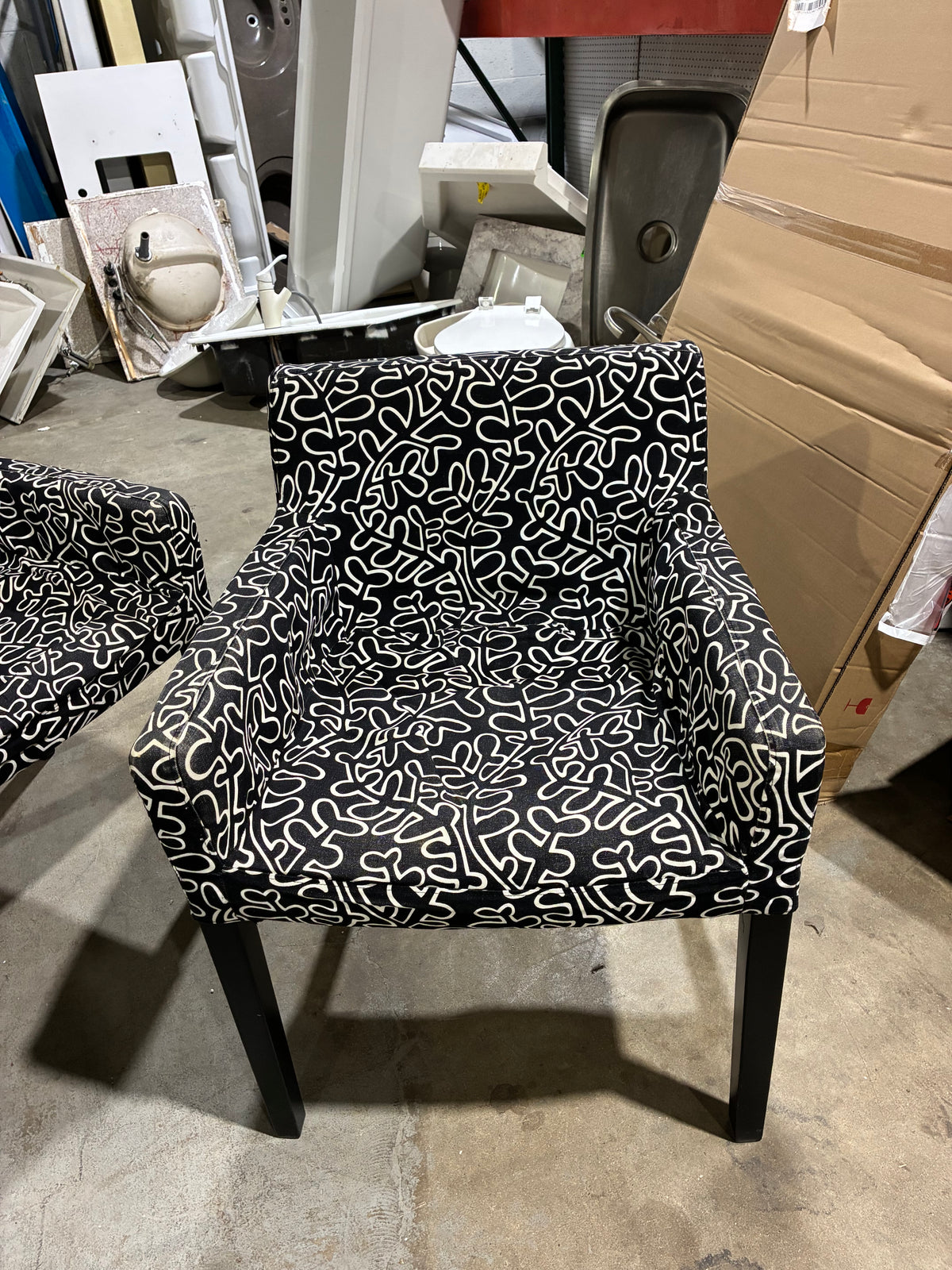 Black Round Pedestal Dining Table with Two Patterned Armchairs
