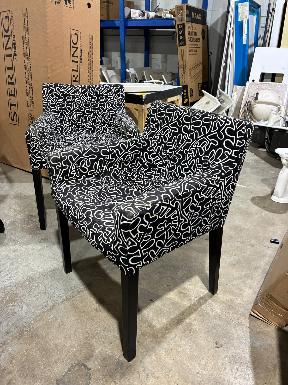 Black Round Pedestal Dining Table with Two Patterned Armchairs