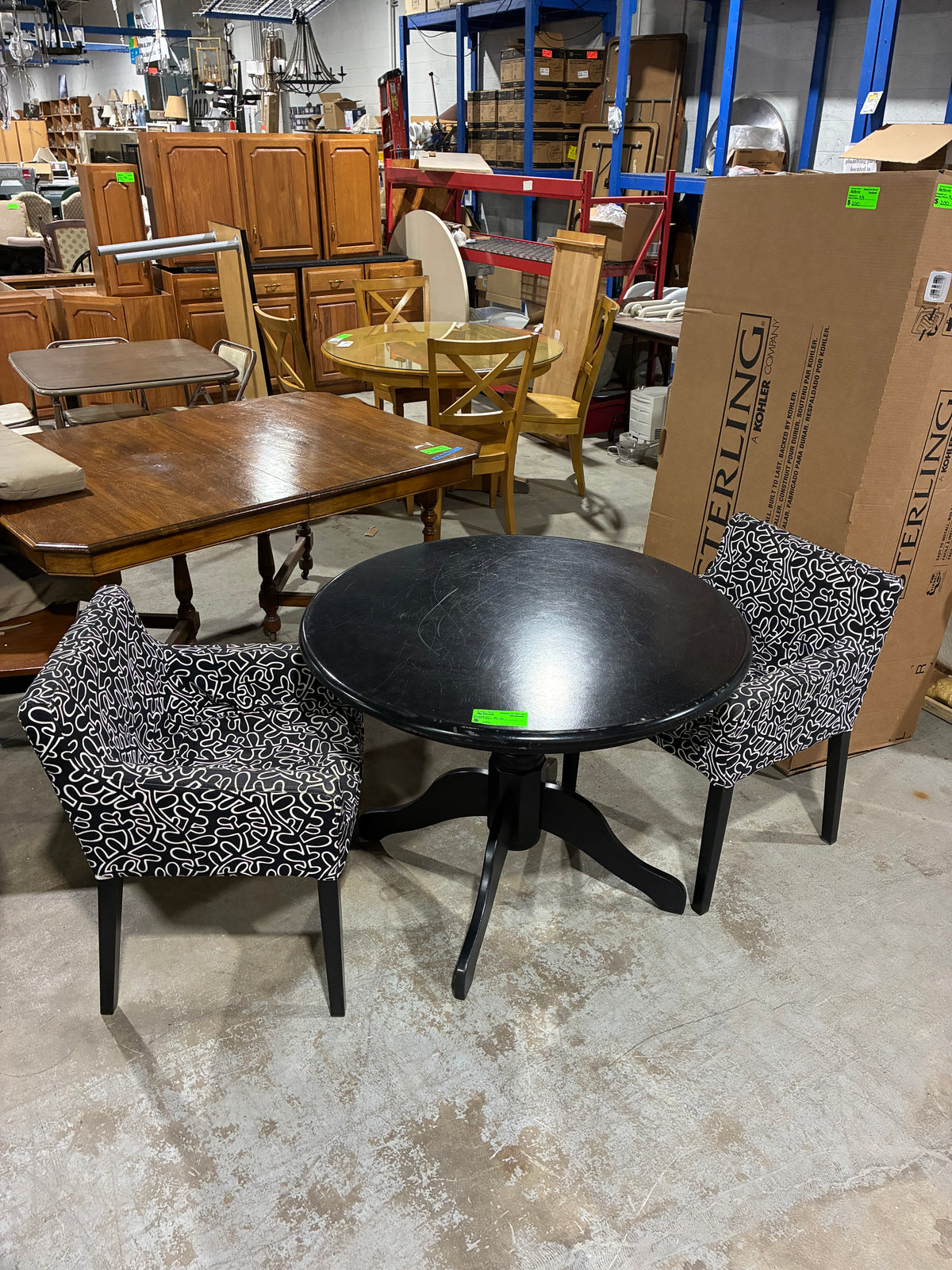 Black Round Pedestal Dining Table with Two Patterned Armchairs