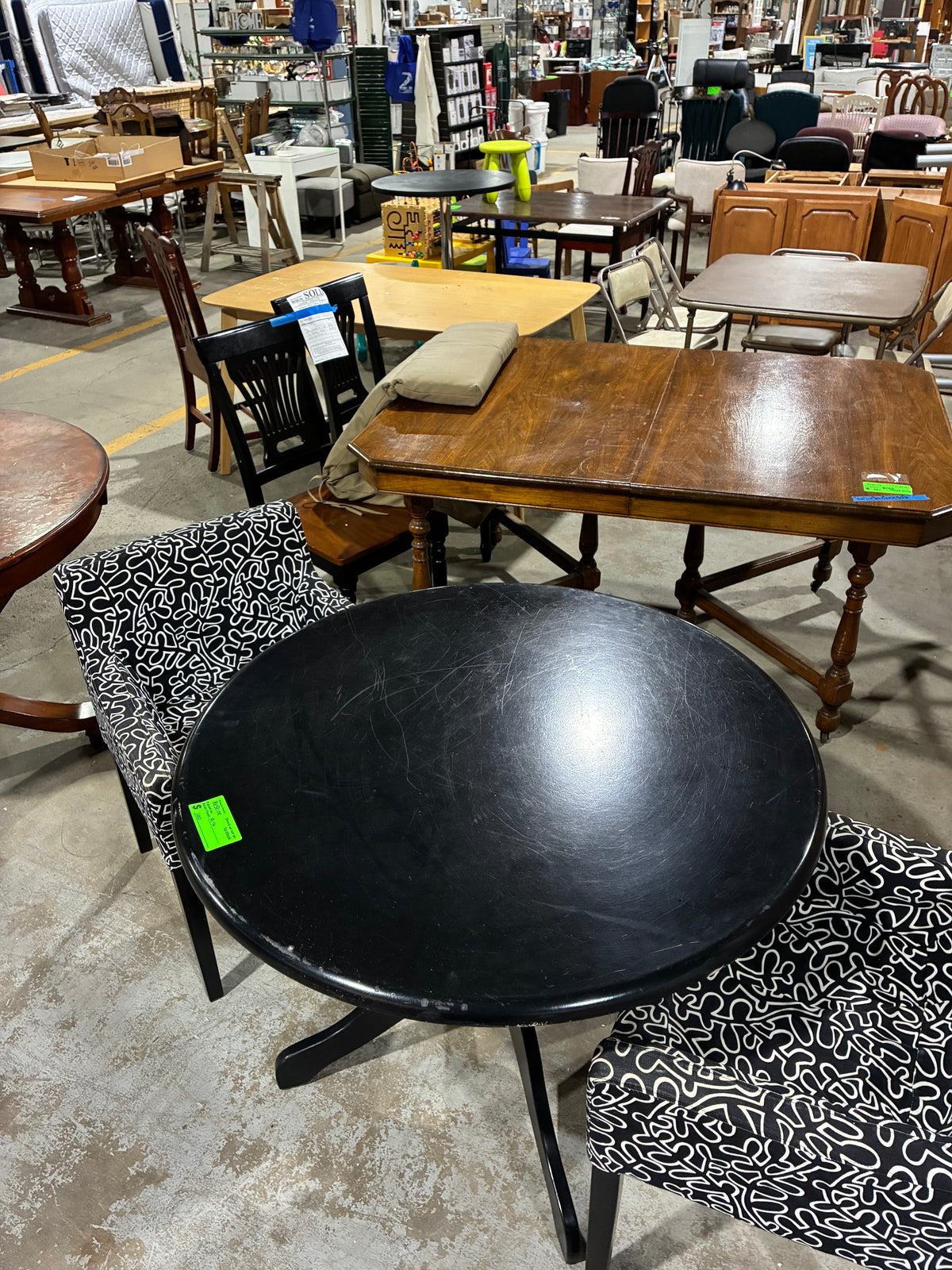 Black Round Pedestal Dining Table with Two Patterned Armchairs